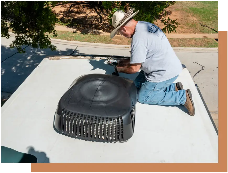 A man sitting on top of the roof of a building.