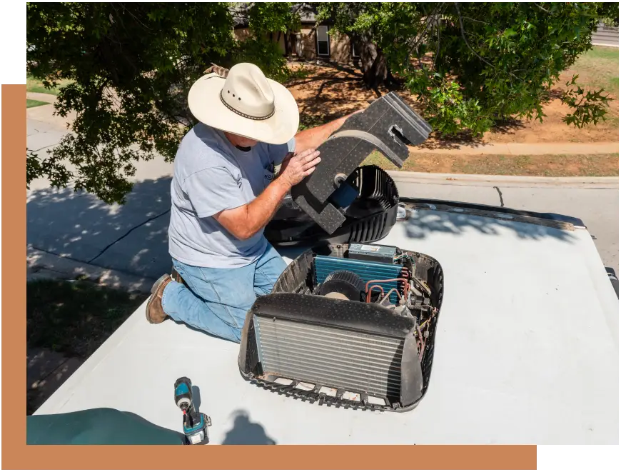 A man sitting on top of a roof with tools.